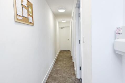 Bright, freshly painted internal hallway with r...