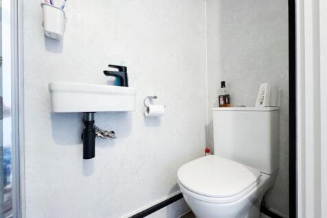 Bright, modern bathroom with a compact wall-mou...