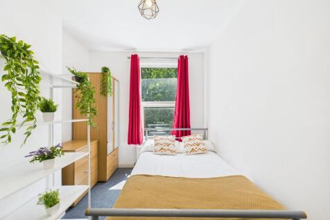 Bright and inviting bedroom featuring a double ...
