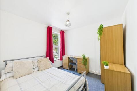 Bright and welcoming master bedroom featuring a...