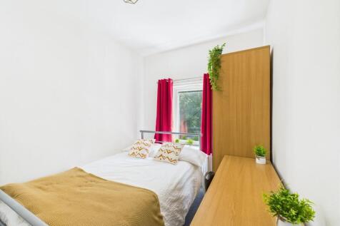 Bright and inviting bedroom featuring a comfort...
