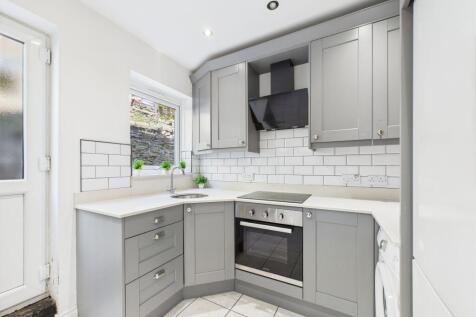 A modern, well-maintained kitchen featuring sle...