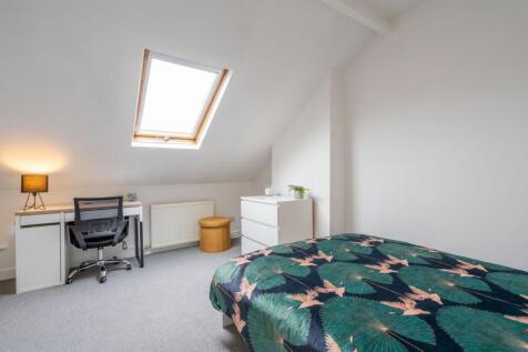 Bright and inviting bedroom with a skylight win...