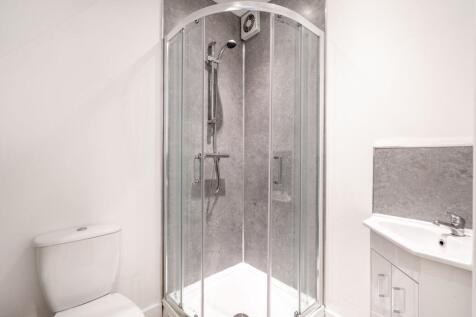 A modern bathroom featuring a spacious shower u...