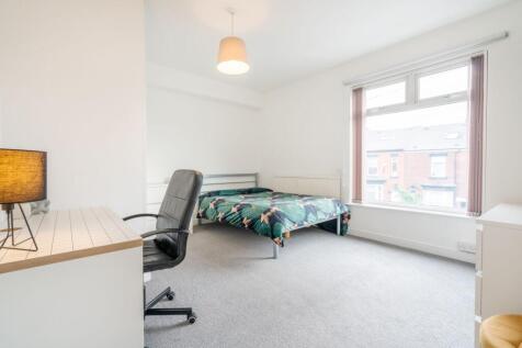 Bright and airy bedroom featuring a comfortable...