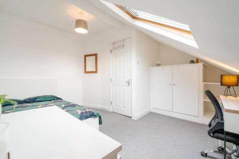 Bright and airy bedroom featuring a comfortable...