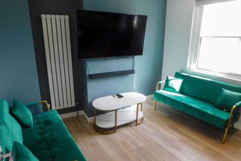 Contemporary living room featuring two vibrant ...