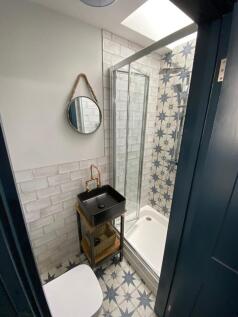Charming modern bathroom with patterned shower ...