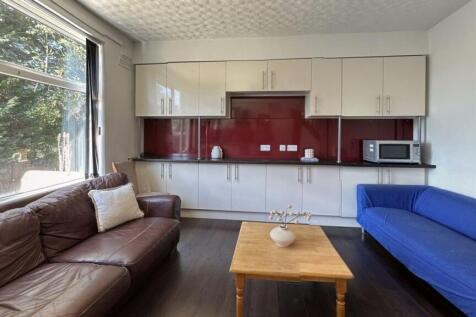 A spacious living room featuring two comfortabl...