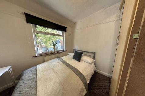 A cozy, well-maintained bedroom featuring a nea...