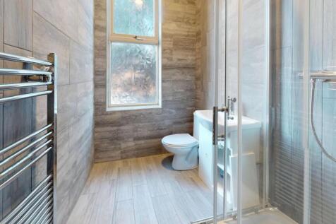 Bright and modern bathroom featuring a large wi...