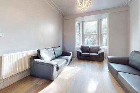 Bright and spacious living room featuring three...