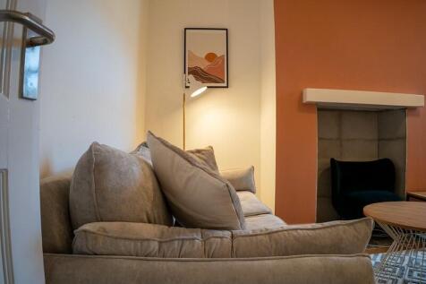 A cozy and inviting living room featuring a com...