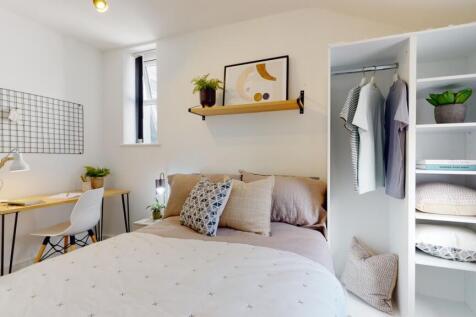 A stylish and well-lit double bedroom featuring...