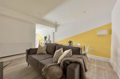 A bright and inviting large modern living room,...
