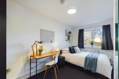 A bright and inviting double bedroom with a sty...