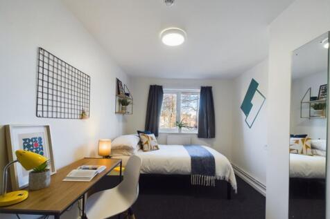 A bright and inviting double bedroom with a coz...
