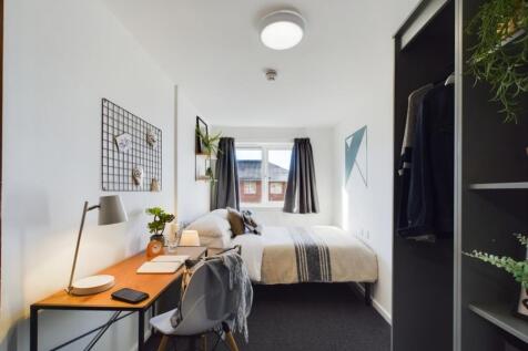 A spacious and inviting double bedroom featurin...