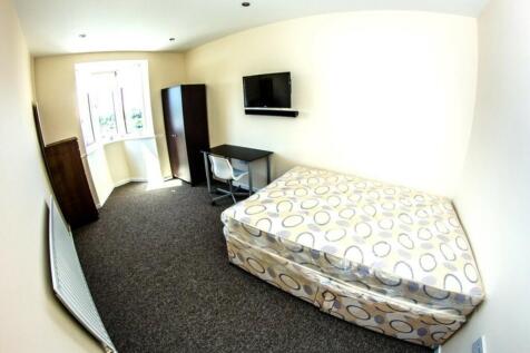 A spacious and well-lit double bedroom with a c...