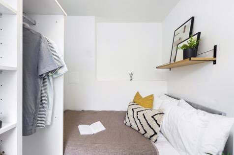 A bright and cozy double bedroom featuring a st...