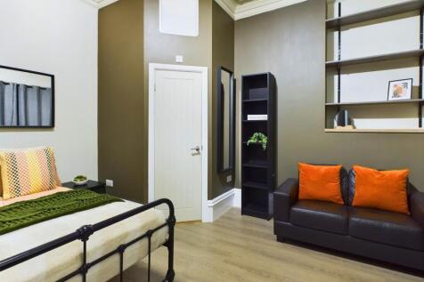 A spacious and stylish double bedroom featuring...