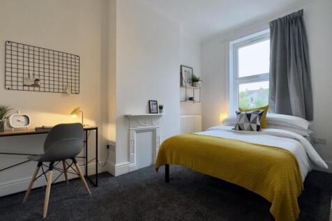 A bright and inviting double bedroom featuring ...
