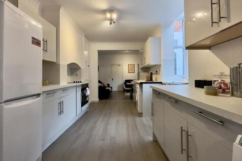 A spacious and modern kitchen with plenty of na...