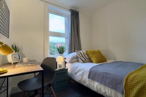 A bright and cozy double bedroom featuring a co...