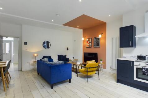 A stylish and spacious modern living room, feat...