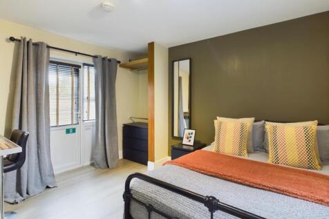 A stylish and inviting double bedroom featuring...