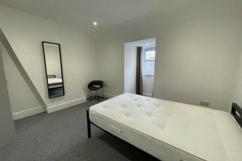 A spacious and well-lit double bedroom perfect ...