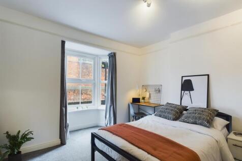 A bright and inviting double bedroom featuring ...