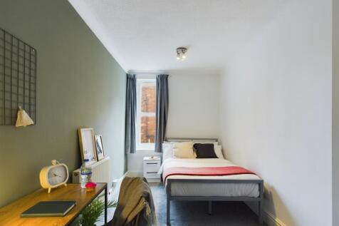 A bright and inviting double bedroom featuring ...