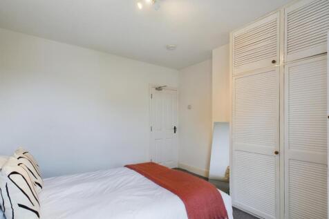 A bright and inviting double bedroom featuring ...