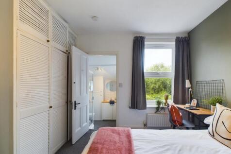 A bright and inviting double bedroom featuring ...