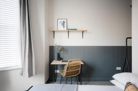 A stylish and well-lit double bedroom featuring...