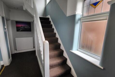 Bright and inviting hallway with natural light ...