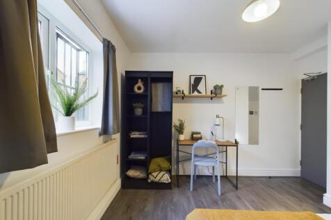 A bright and inviting double bedroom with a stu...