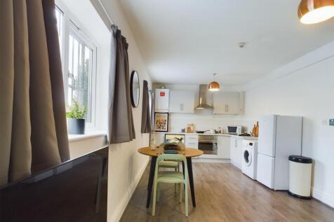 A bright and modern kitchenette with ample spac...