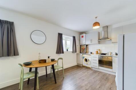 A bright and inviting kitchenette featuring mod...