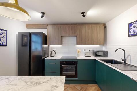 Modern fitted kitchen with two-tone cabinetry, ...