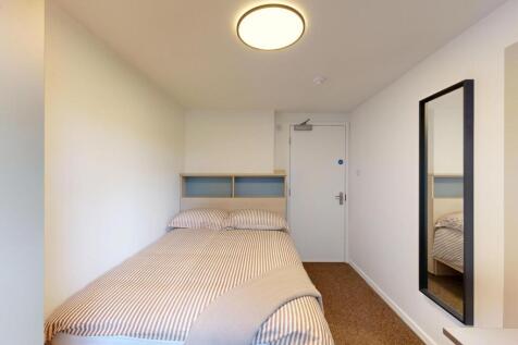 Bright, neatly presented bedroom with a comfort...
