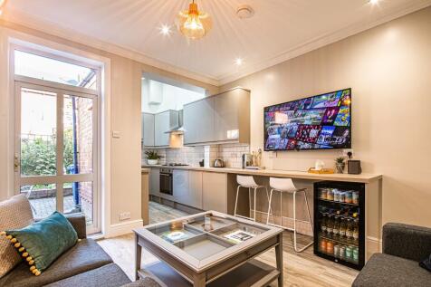 A modern and welcoming living room featuring a ...