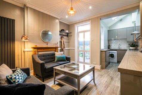 A bright and welcoming living room featuring a ...