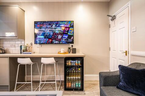 A modern living room with a large flat-screen T...