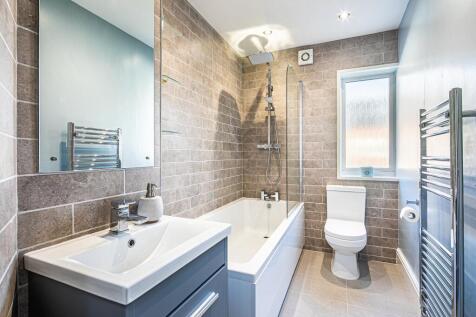 Modern bathroom featuring a spacious bath, larg...