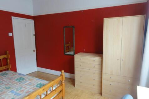 Bright and welcoming double bedroom featuring a...