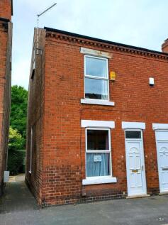 Red-brick end-terrace with clean white front do...
