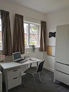 Bright, tidy workspace with a desk by a large w...