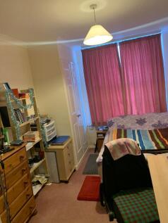 Bright, cozy bedroom with a double bed, desk an...